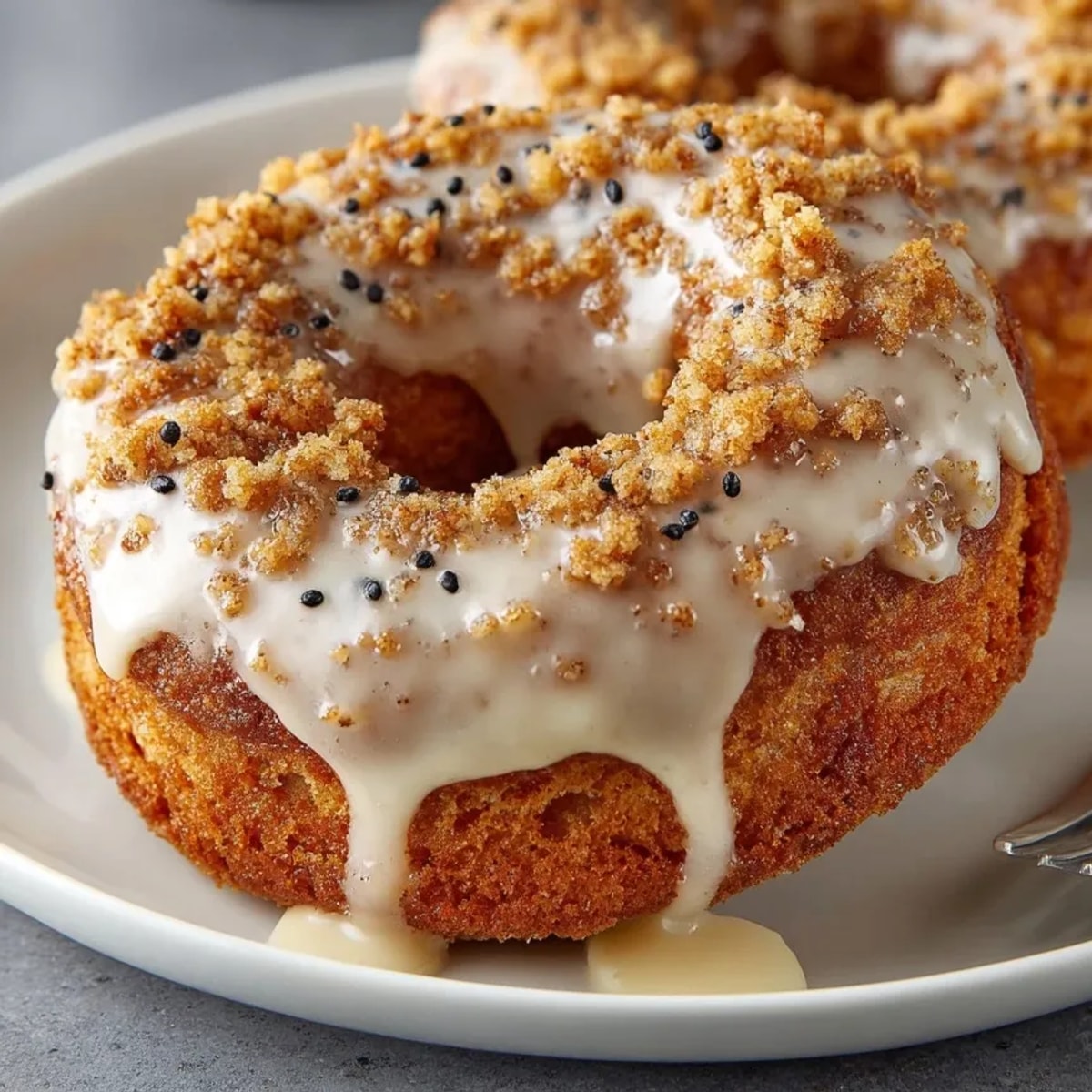 Freshly baked apple cider donuts drizzled with vanilla glaze, wonderfully spiced and delicious looking.