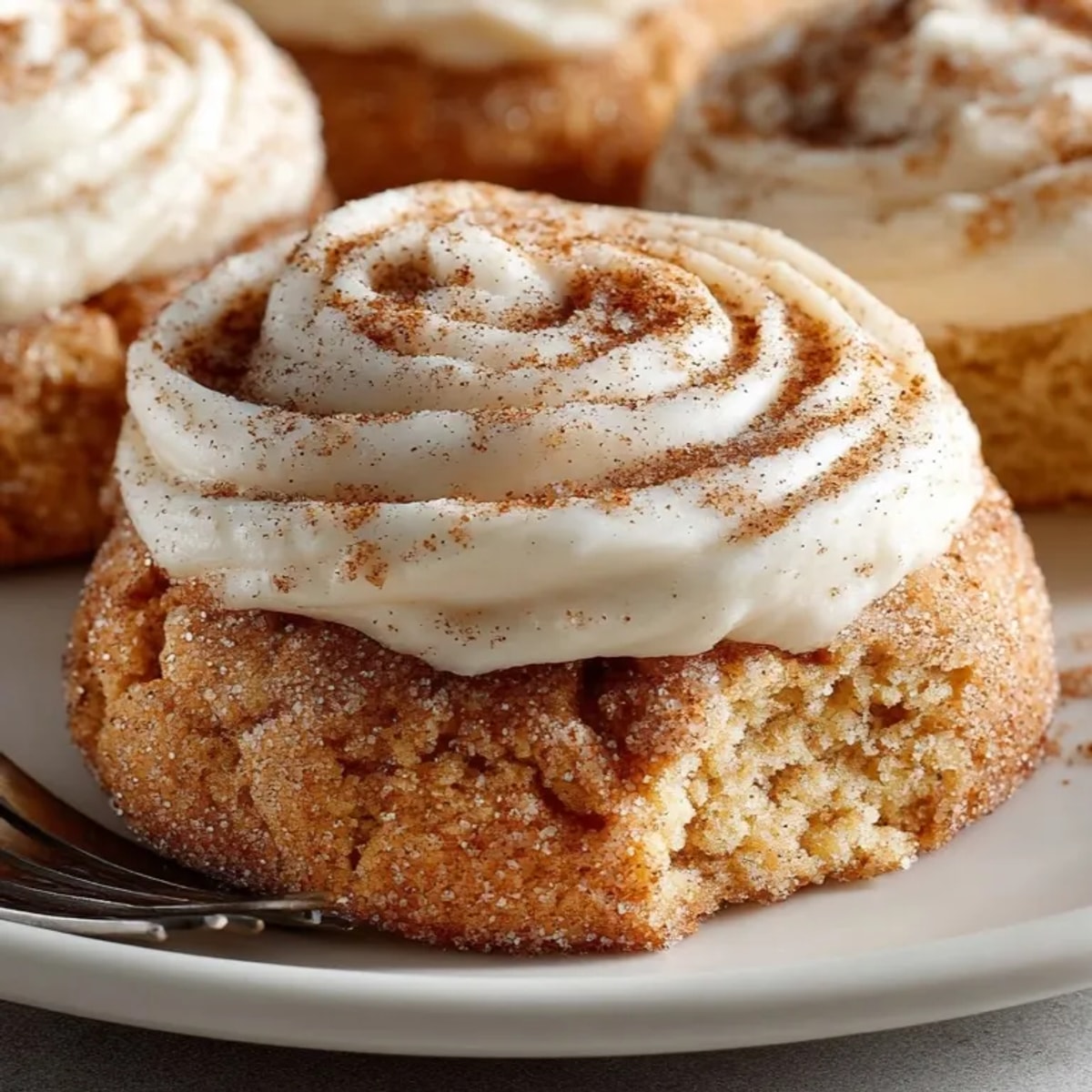 Cinnamon Sugar Cloud Cookies with Cream Cheese Frosting freshly baked and dusted, perfect for dessert lovers.