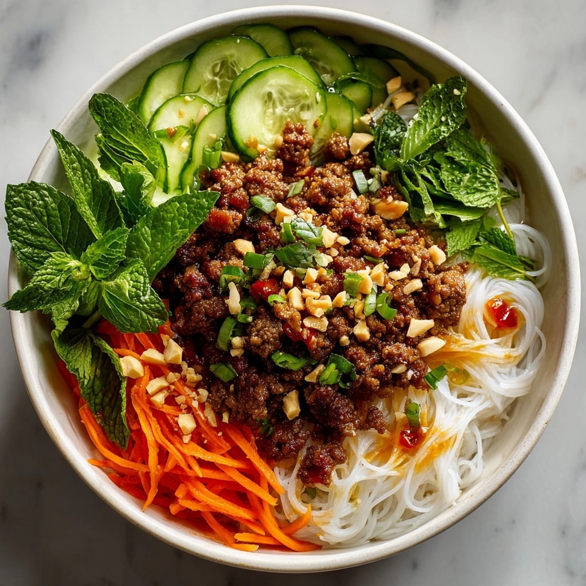 Vietnamese-Inspired Lemongrass Beef Noodle Bowls displayed with fresh herbs, pickled vegetables, and savory nuoc cham sauce.