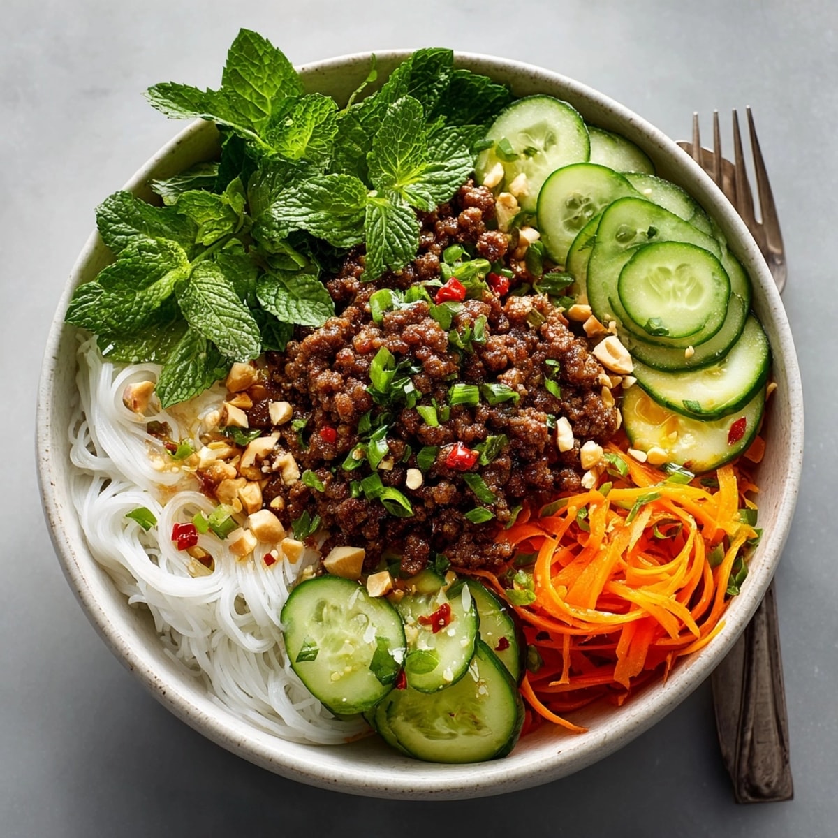 Vibrant Vietnamese-Inspired Lemongrass Beef Noodle Bowls served in white bowls, ready for a light summer meal.