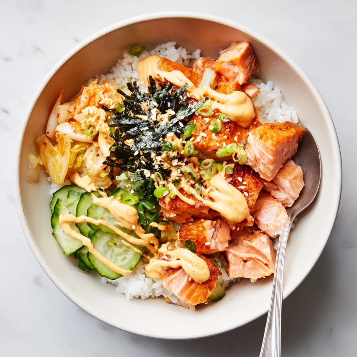 Crispy Salmon Rice Bowl garnished with vibrant kimchi and creamy avocado slices.  