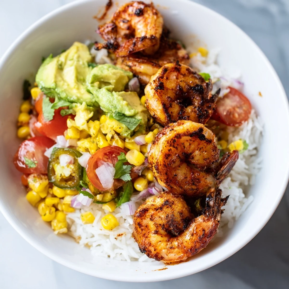 Juicy grilled shrimp nestled in flavorful Easy Grilled Shrimp Bowls with a vibrant avocado salsa.