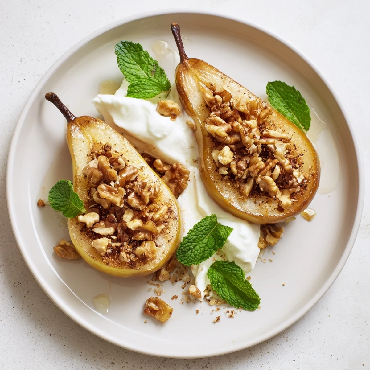 Golden-brown roasted pears, topped with walnuts and creamy Greek yogurt, showcase this easy recipe.