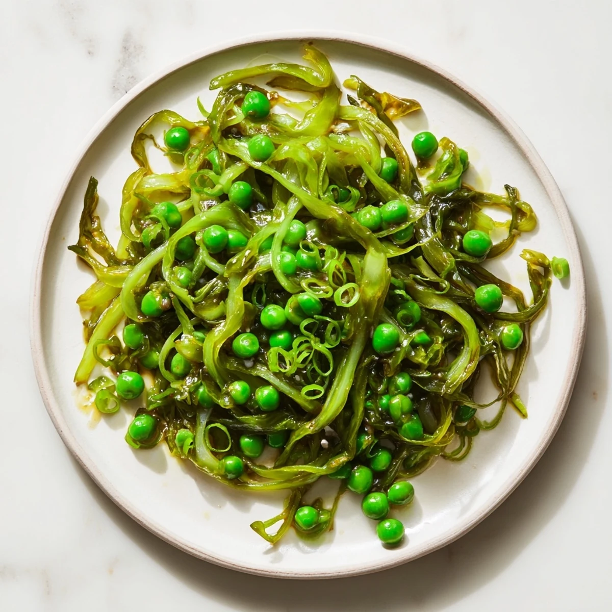 Savory cabbage stir-fry with garlic, soy & peas, a quick & easy vegetarian dish.