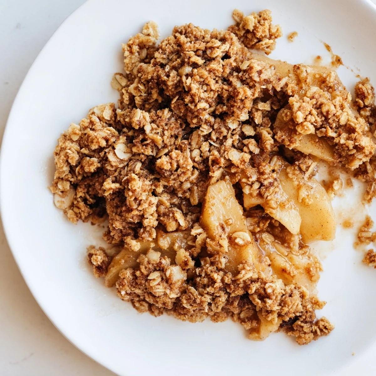 Warm, bubbly Apple Crisp with oat topping, showcasing juicy apples perfect for dessert.