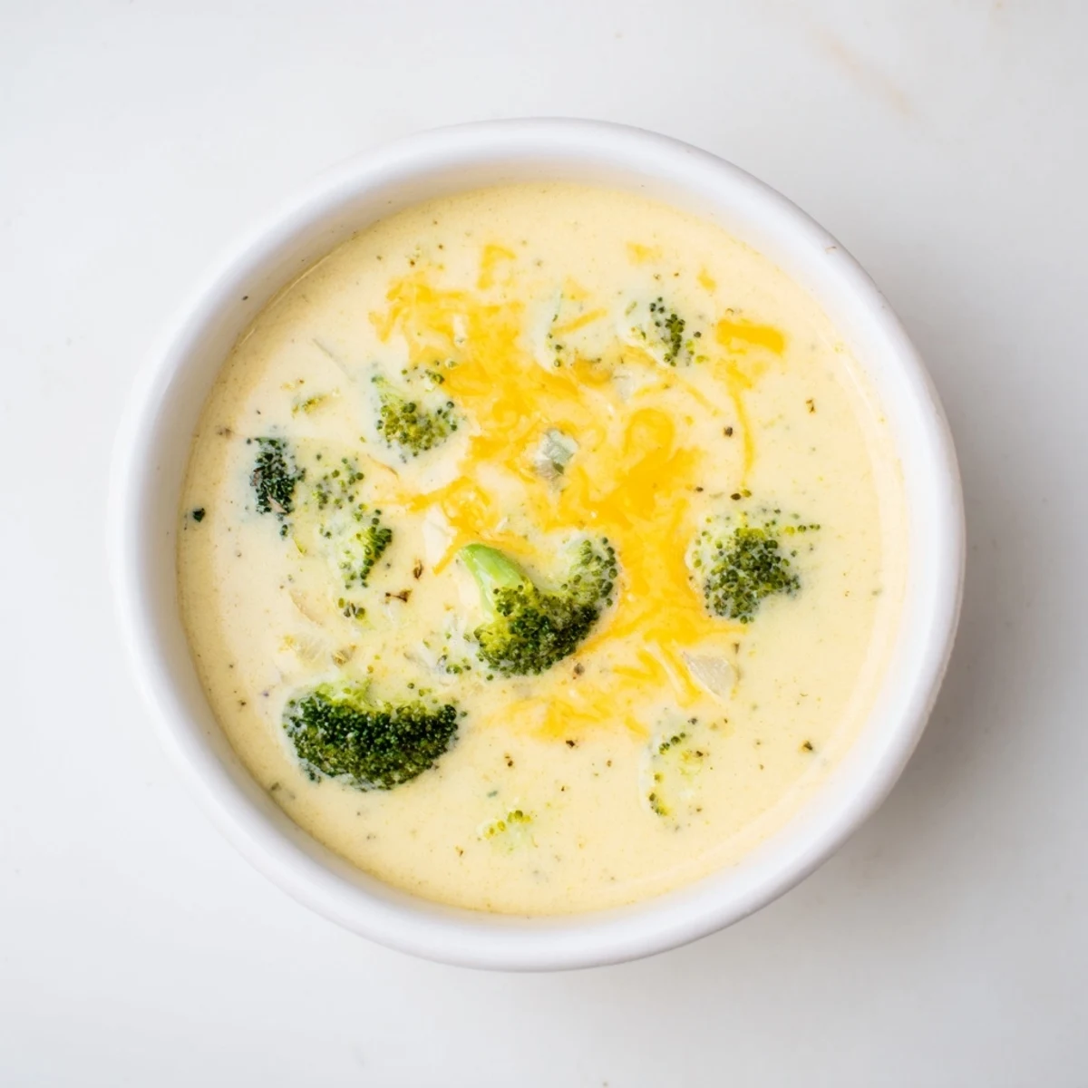 Broccoli Cheese Soup: A steaming bowl of creamy soup with visible cheddar cheese, ready to warm you.
