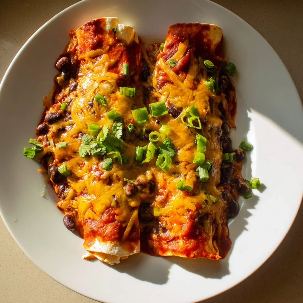 Mouthwatering close-up of cheesy, baked Cheesy Bean Enchiladas, perfect for a family dinner.