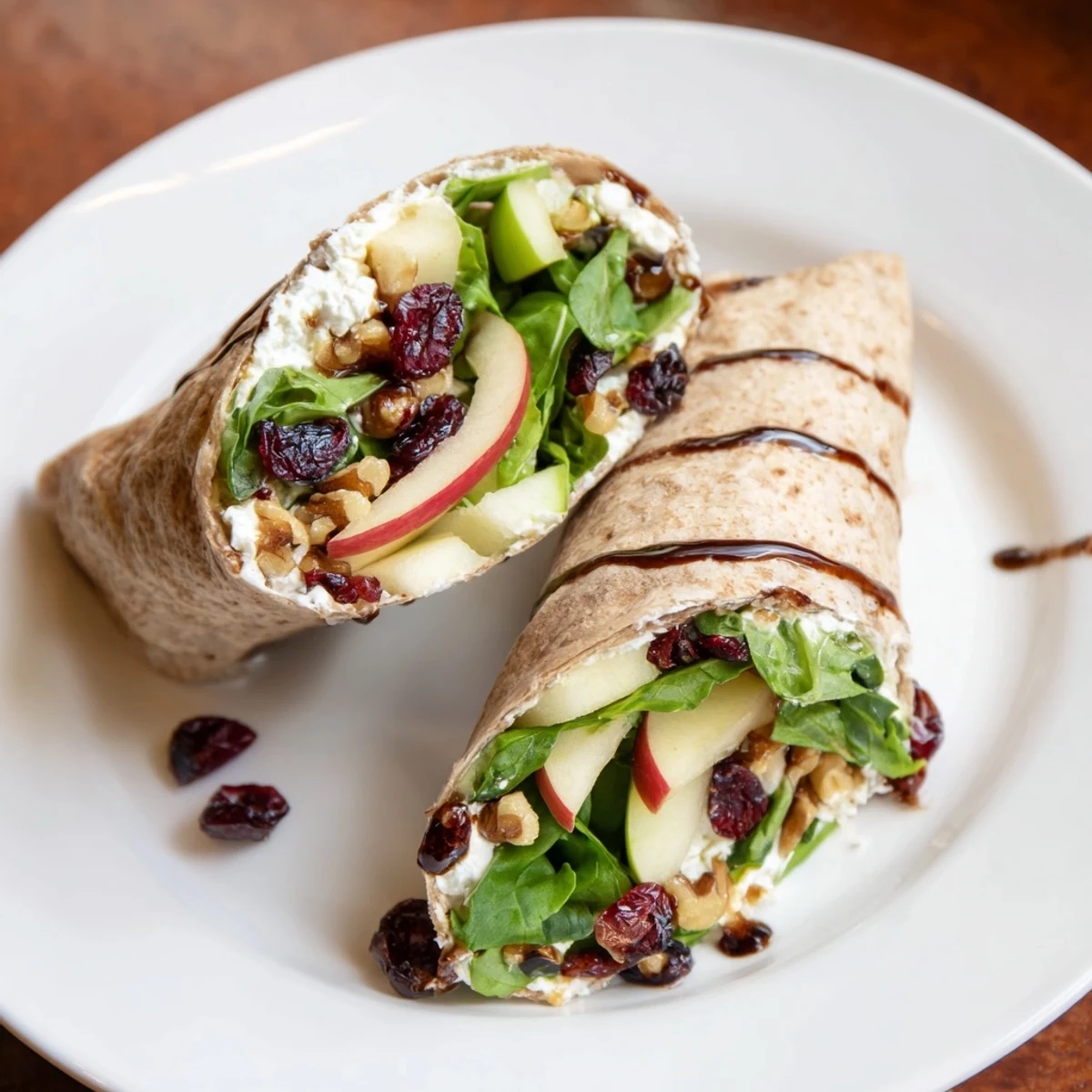 A close-up of a Cranberry Goat Cheese & Walnut Wrap, showcasing sweet cranberries and creamy filling.