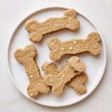 Freshly baked Pawsitively Good Dog Bone Treats arranged on a cooling rack, fragrant and delicious for dogs.