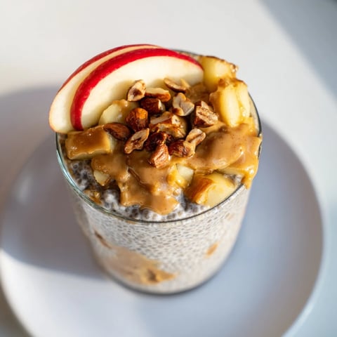 Creamy Apple-Chia Pudding with Peanut Butter layered for serving, showcasing fresh apples and peanut butter swirl.