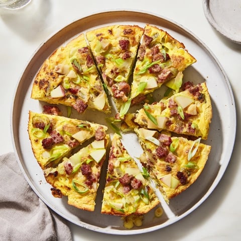 Golden Savory Apple, Sausage, and Cheddar Scone Skillet, served warm, with visible, bubbly cheese.