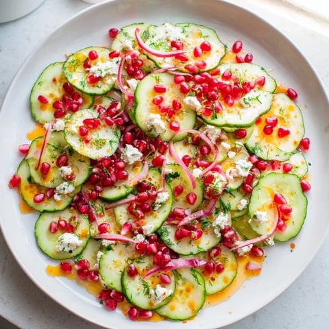 Fresh Healthy Cucumber Christmas Salad, a vibrant mix of cucumbers, pomegranate, and citrus dressing ready to serve.