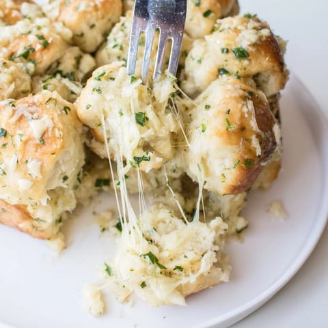 Buttery, herby Garlic Parmesan Monkey Bread chunks glistening, ready for sharing and dipping.
