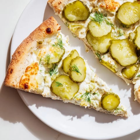 Delicious Pickle Pizza features melty mozzarella and vibrant dill, perfect for adventurous eaters.  