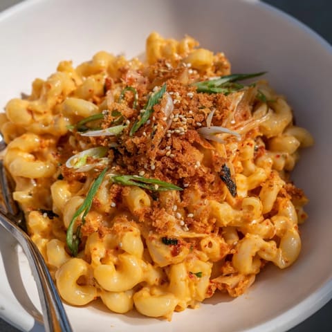 Indulge in Spicy Kimchi Mac & Cheese, a fusion dish with vibrant colors.  