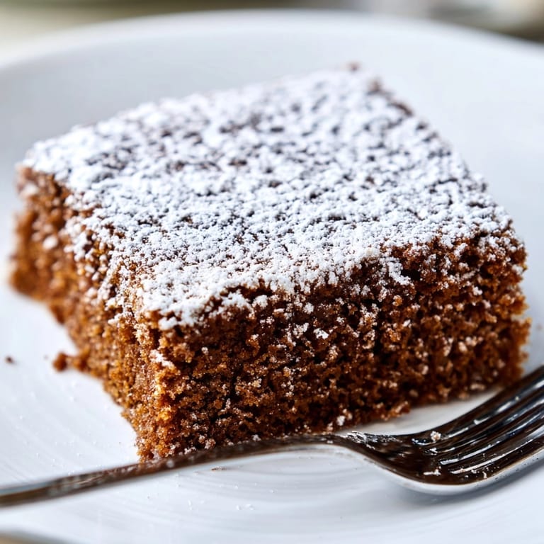 Golden brown Cinnamon Gingerbread Snack Cake cooling on a wire rack, aromatic and delicious.