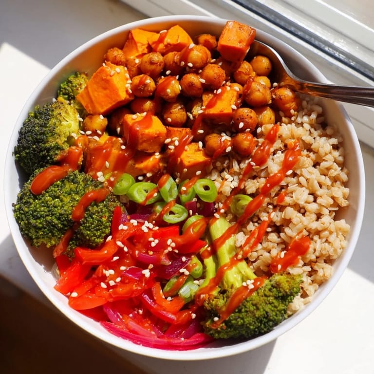 Delicious grain bowls featuring gochujang-maple sauce, chickpeas, and colorful vegetables.  