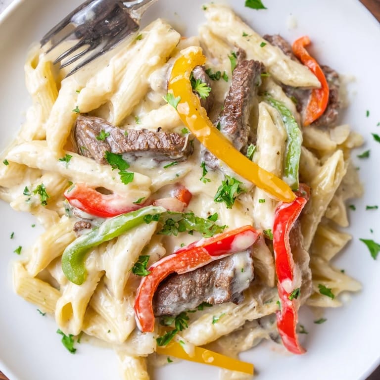 Sautéed peppers and steak combine in rich Philly Cheese Steak Pasta perfection.
