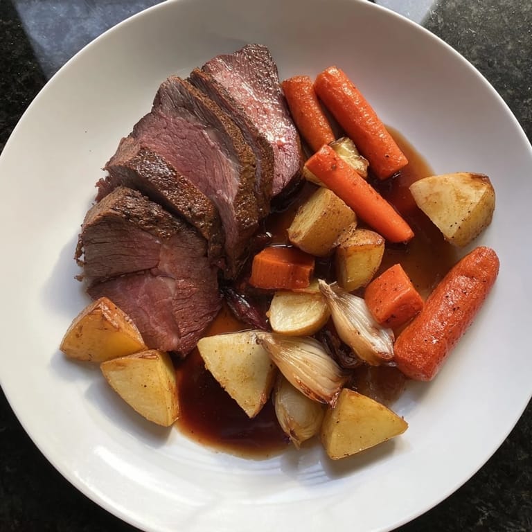 Hearty chunks of Sunday Pot Roast and vegetables simmer in savory juices, perfect for dinner.