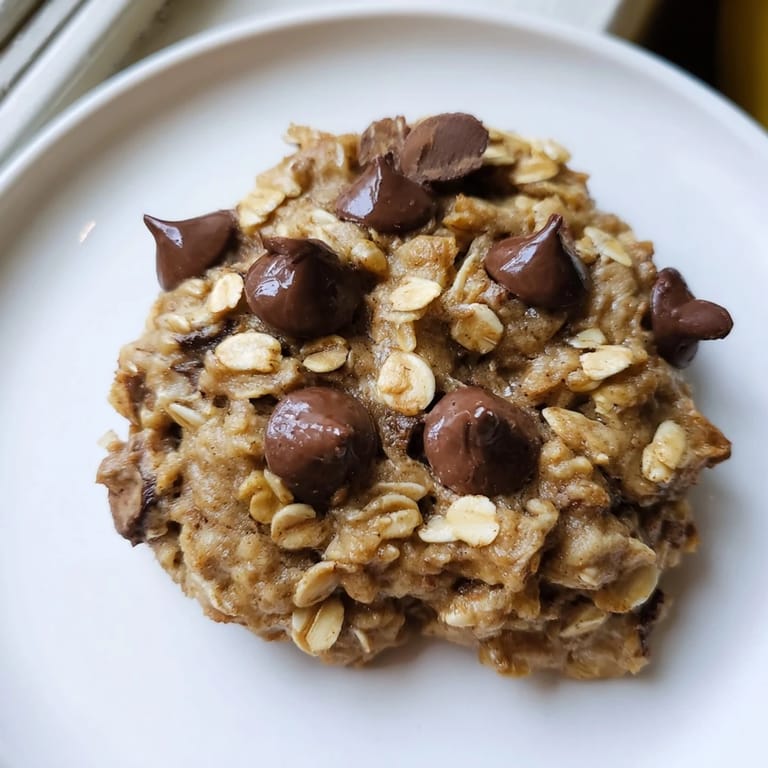 A stack of freshly baked Oat-Banana Chocolate Chip Cookies, perfect for a sweet treat.