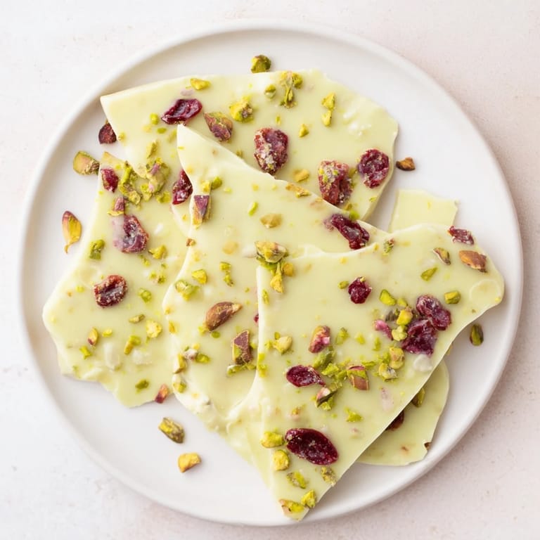 Vibrant green matcha swirl through white chocolate in these delicious cranberry bark clusters.