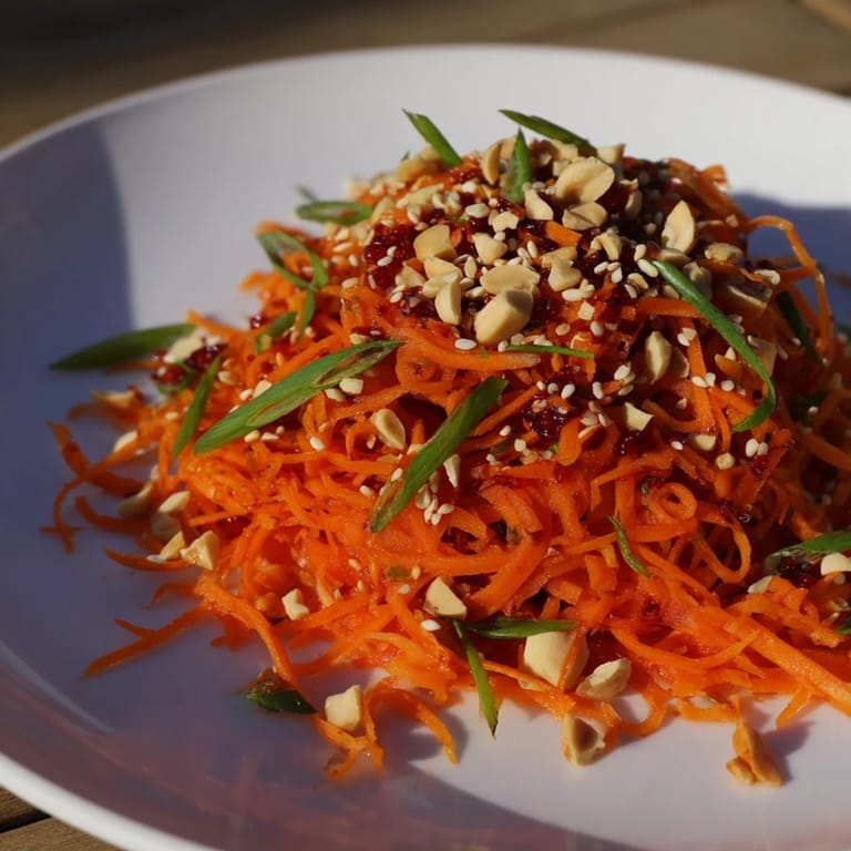 Delicious, refreshing Spicy Carrot Salad ready to serve, with chopped peanuts on top, perfect for a side.